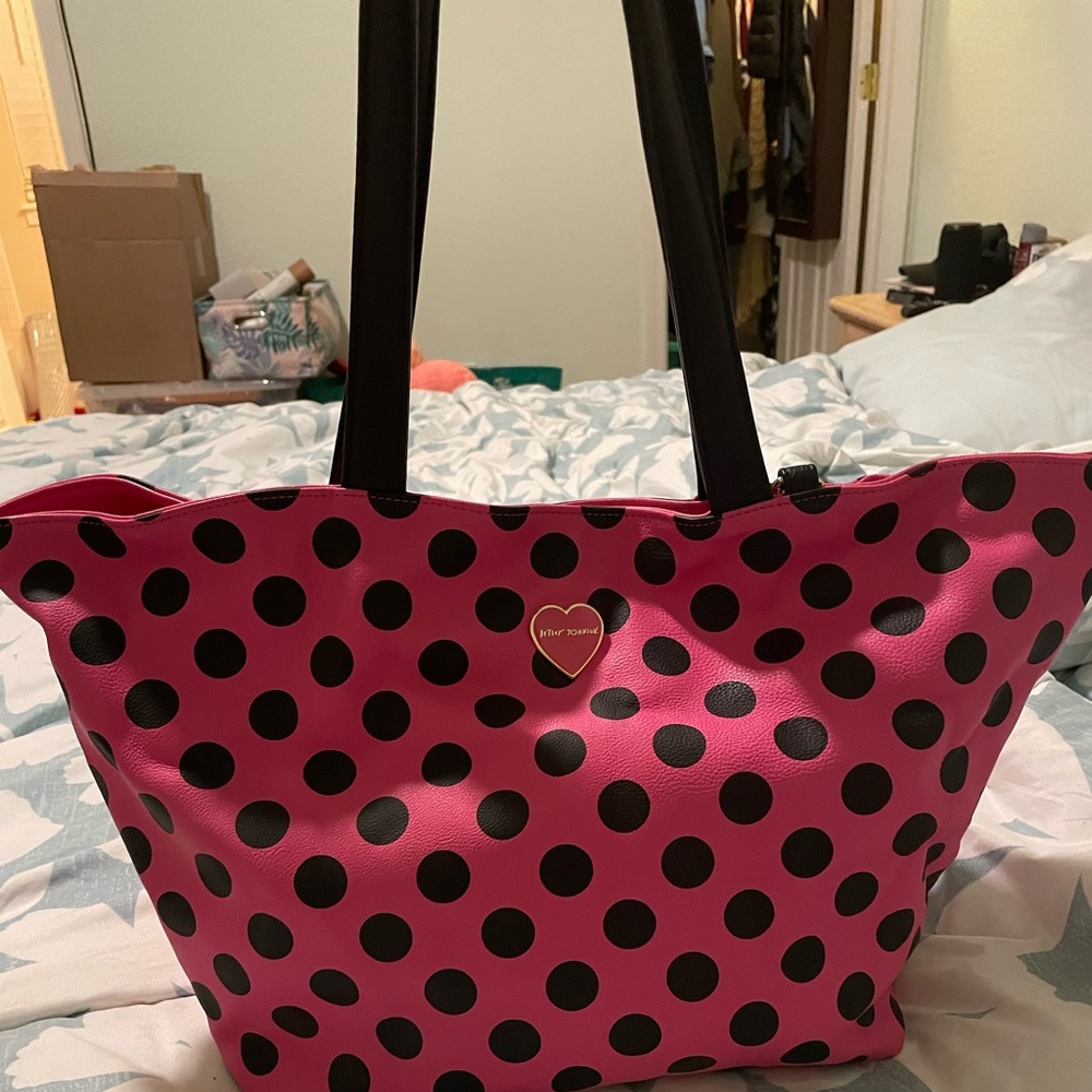 Cute pink and black polka dot purse with an attached handbag.